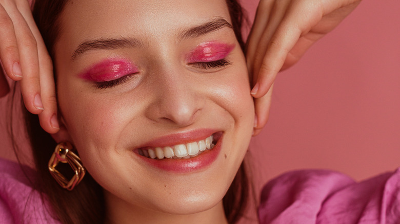 woman smiling with pink eyeshadow