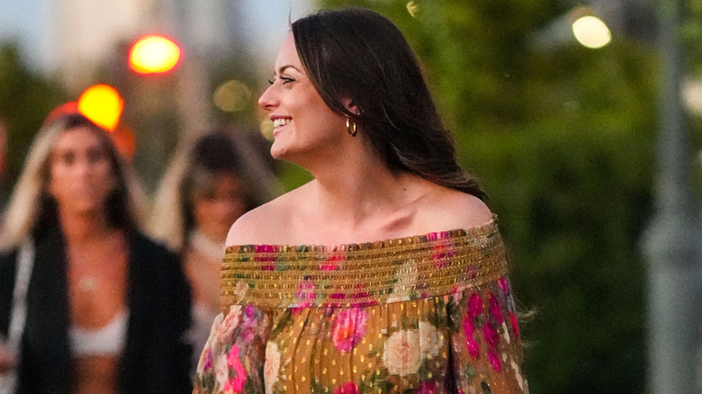 woman wearing floral off the shoulder dress