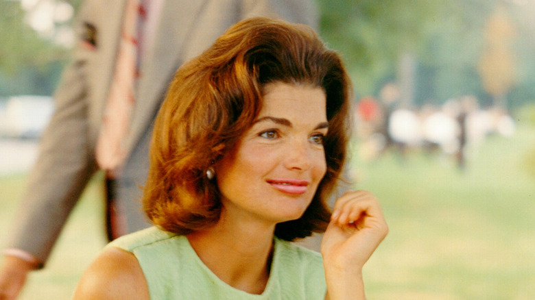 Jacqueline Kennedy posing in a green dress