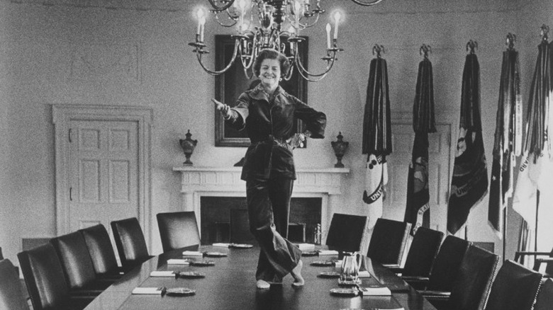 Betty Ford standing on the Cabinet Room table