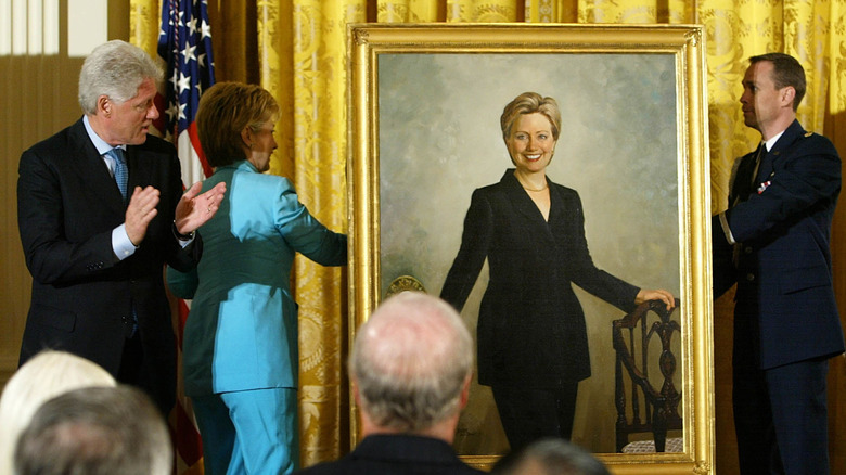 Hillary Clinton next to her official first lady portrait