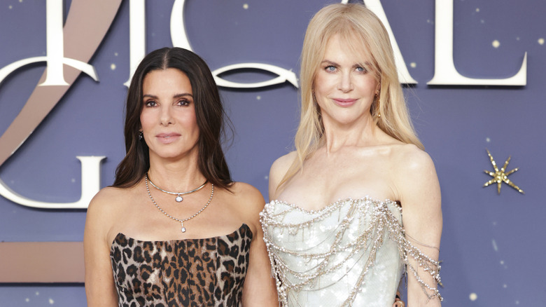 Sandra Bullock posing with her arm around Nicole Kidman