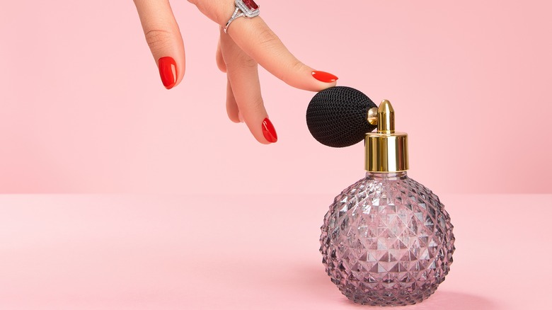 Person touching a perfume bottle