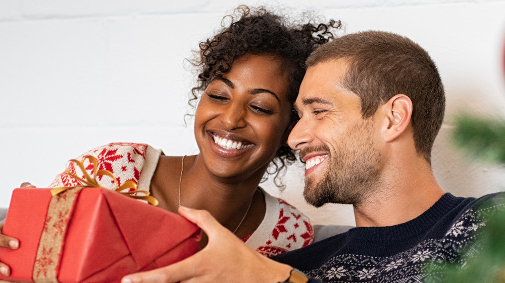 man giving woman holiday gift