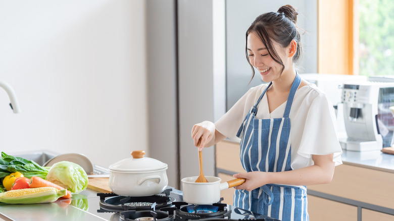 Woman smiling while cooking