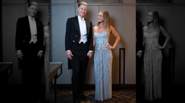Abby Wambach smiling in a tuxedo next to Glennon Doyle.