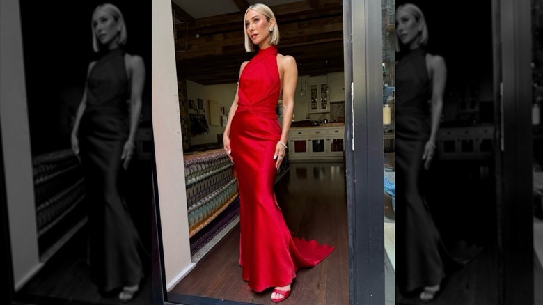 Ashley Avignone standing in a doorway wearing a halter red dress