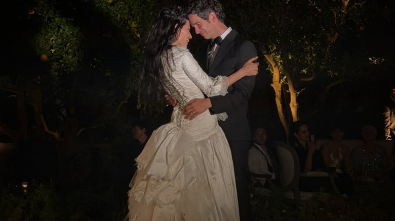 Gabbriette and Matty Healy in an embrace, with foreheads touching, at their wedding.