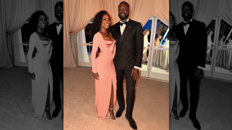 Gabrielle Union, in a pastel pink dress, arm-in-arm with Dwyane Wade.