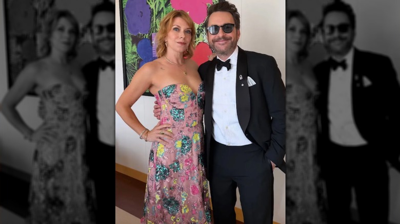 Mary Elizabeth Ellis, in pastel pink floral gown, arm-in-arm with Charlie Day.
