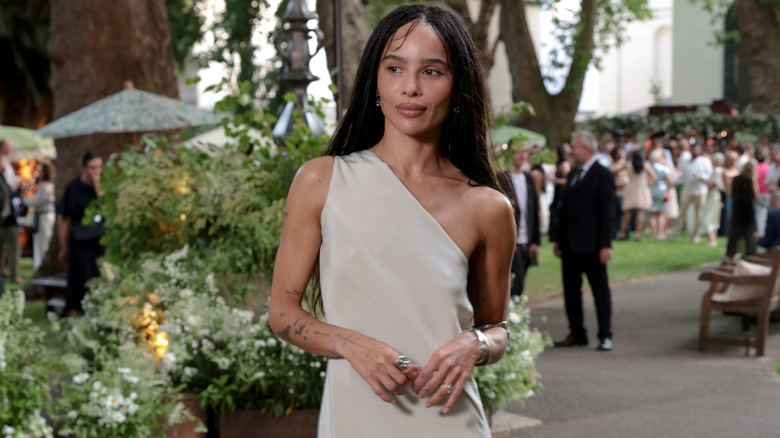 A close up of Zoë Kravitz at the 2026 Summer Solstice Party, wearing an asymmetrical slip dress.