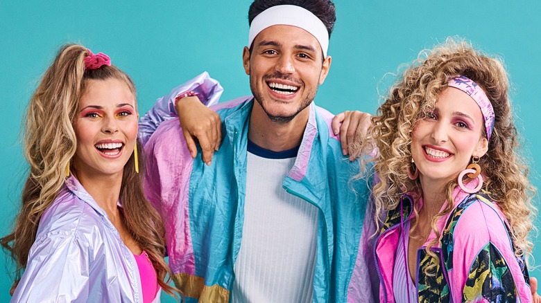 three people smiling in workout gear