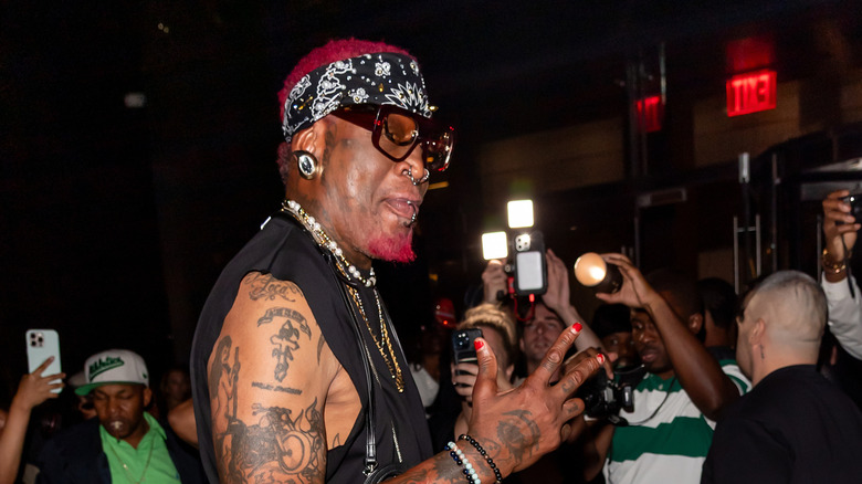 Dennis Rodman surrounded by photographers