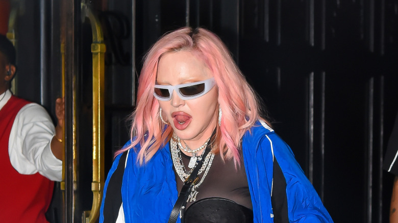Madonna walking out of a building