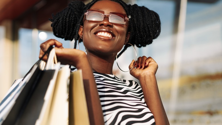 woman holding a lot of shopping bags