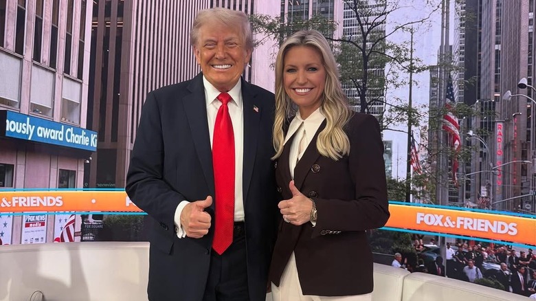 Ainsley Earhardt and Donald Trump pose on Fox & Friends