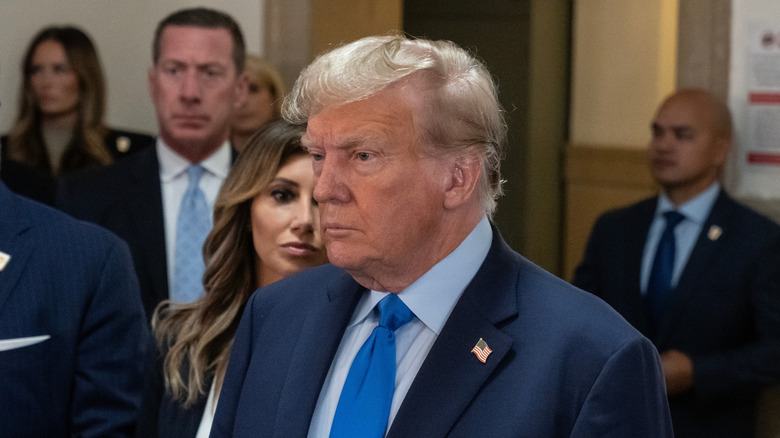 Donald Trump speaks to the press after the first day of his civil fraud trial at the NYS