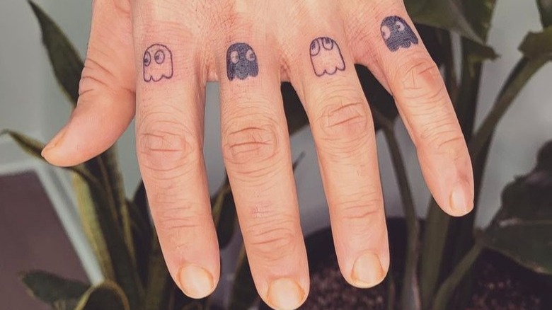 Fingers with Pac-Man tattoos