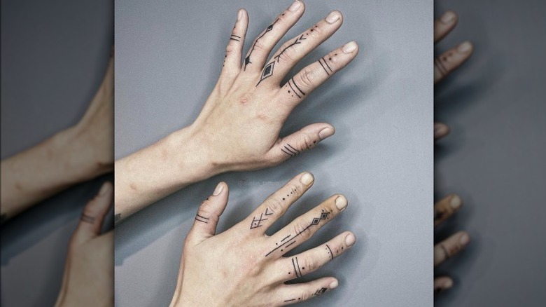 Hands with line work tattoo