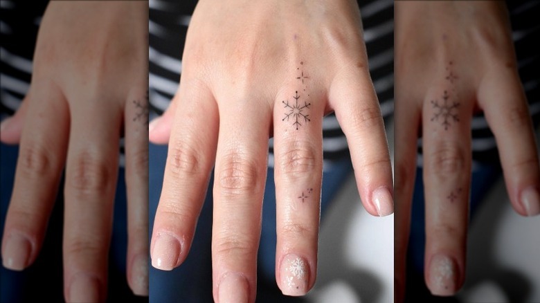 Hand with delicate snowflake tattoos