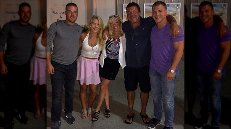 Karoline Leavitt smiles while posing with several other people