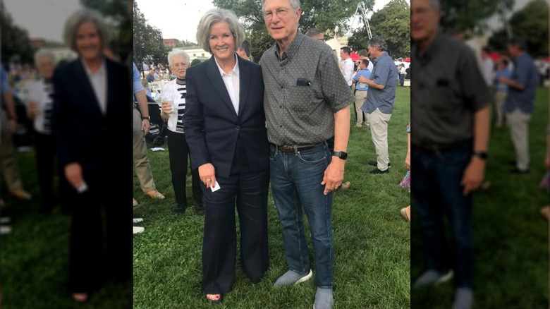 Susie Wiles poses next to a congressman at an outdoor event