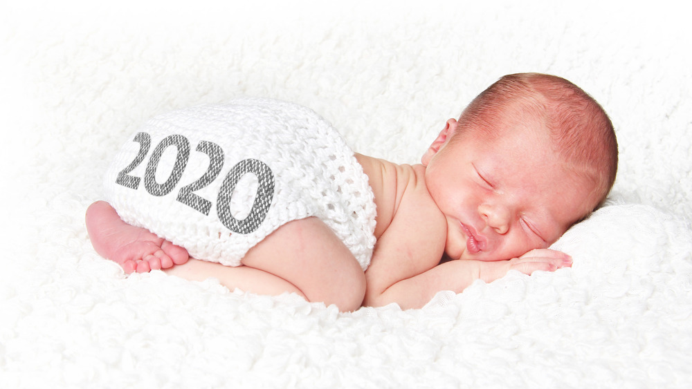 Baby with 2020 on diaper