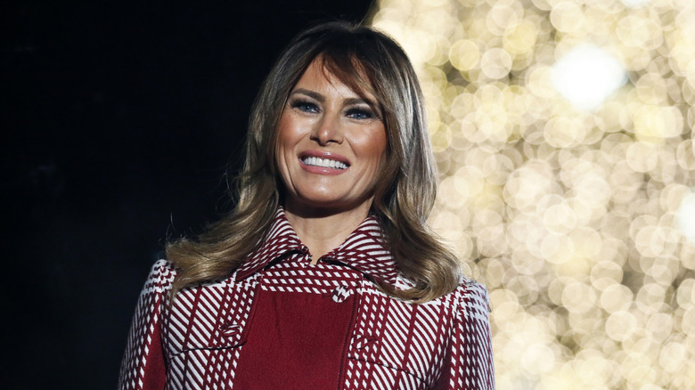 Melania Trump listens as U.S. President Donald Trump speaks during the 97th Annual National Christmas Tree Lighting ceremony