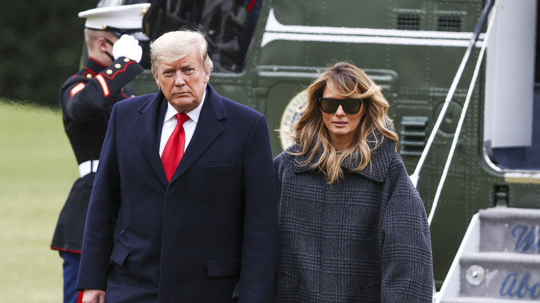 U.S. President Donald Trump and First Lady Melania Trump walk on the South Lawn of the White House after arriving on Marine One in Washington, D.C., U.S., on Thursday, Dec. 31, 2020