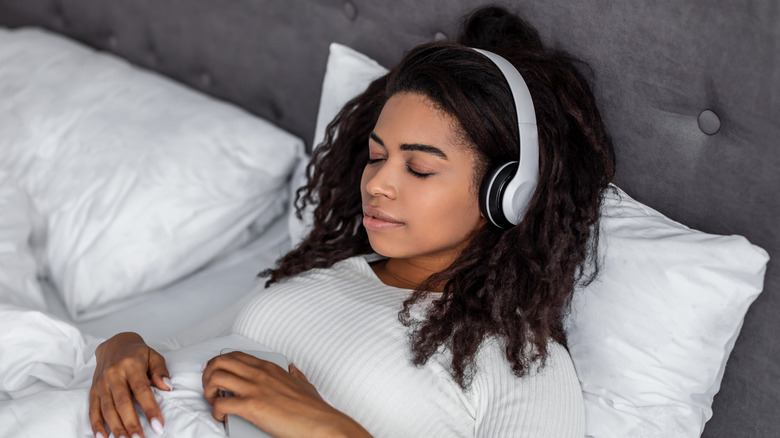 Woman sleeping with headphones on