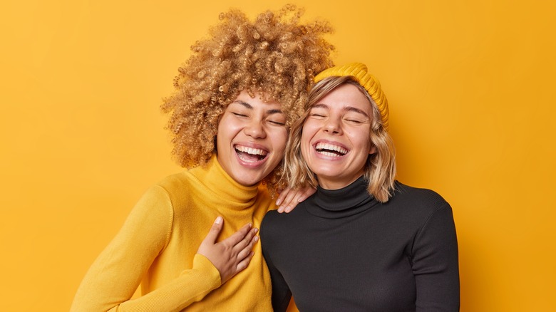 Women laughing in turtlenecks