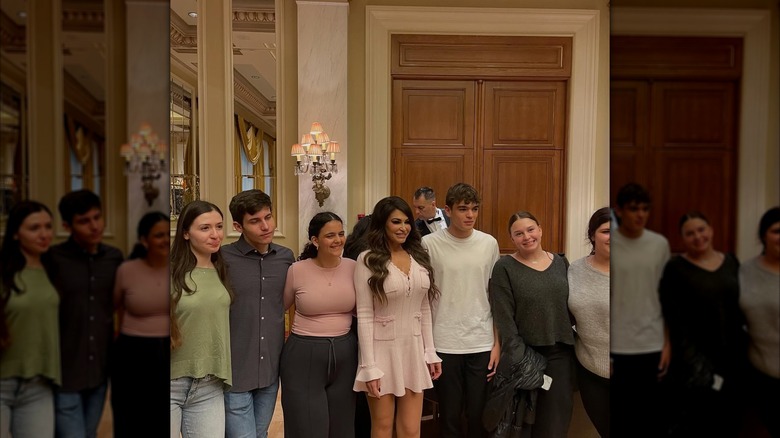 Kimberly Guilfoyle smiles for a photo at a reception with other guests