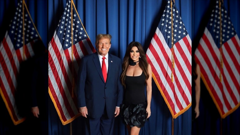 Kimberly Guilfoyle poses with President Donald Trump beside American flags