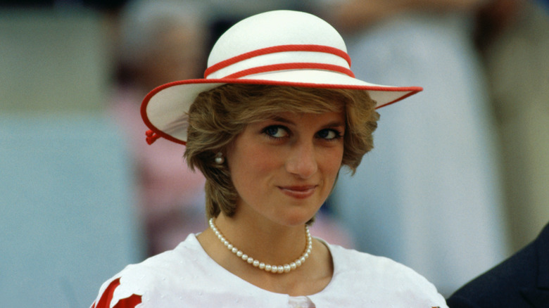 Image of Princess Diana wearing a red and white ensemble and matching red and white hat