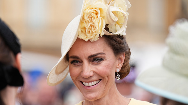 Close-up of Princess Catherine smiling in yellow hat