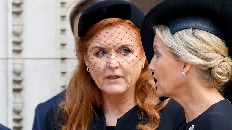 Sarah Ferguson wearing black birdcage veil at funeral and looking at Sophie, Duchess of Edinburgh