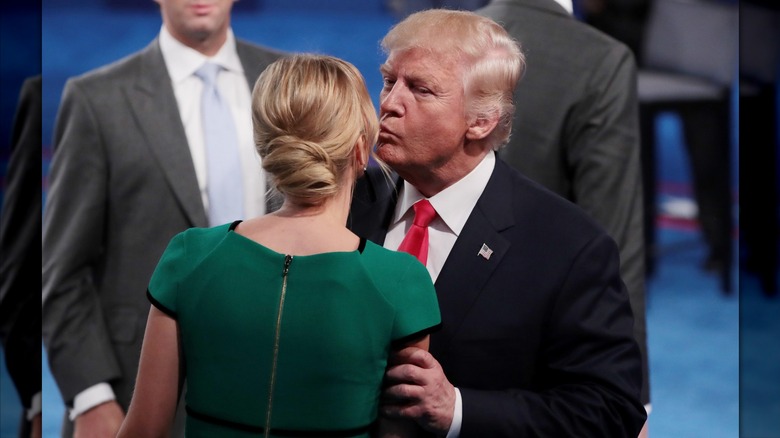 Donald Trump grabbing Ivanka Trump's arm and kissing her on the cheek during the second presidential debate in 2016.
