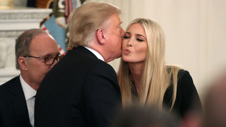 Ivanka Trump puckering her lips and closing her eyes as Donald Trump kisses her on the cheek in the State Dining Room in 2018.
