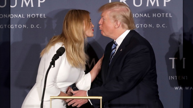 Ivanka Trump and Donald Trump leaning in to kiss each other at the ribbon-cutting ceremony for the Trump International Hotel in D.C.