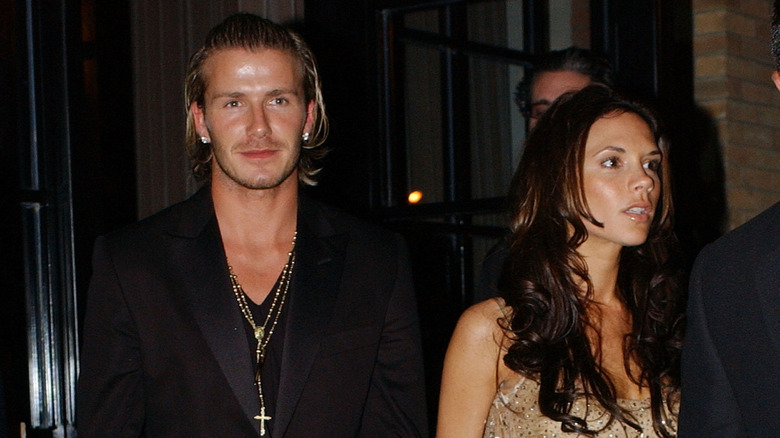David Beckham and Victoria Beckham walking down the street in New York