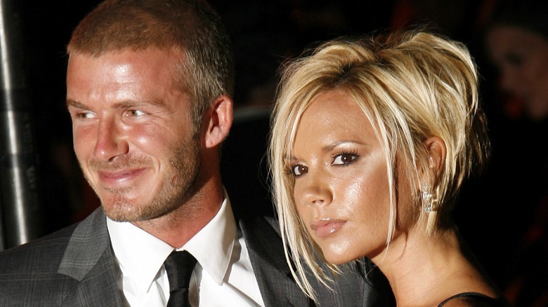 David and Victoria Beckham pose for a photo at a red carpet event