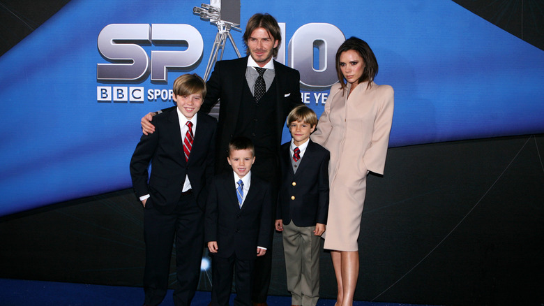 David and Victoria Beckham pose with their three sons at a red carpet event
