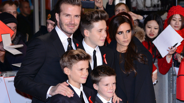 David and Victoria Beckham pose with their three sons at a red carpet event