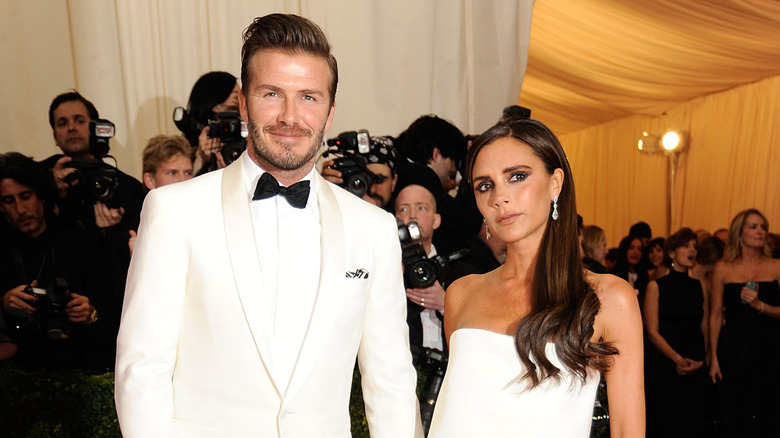 David and Victoria Beckham hold hands in matching white outfits at the Met Gala