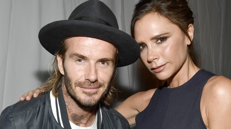 David and Victoria Beckham share a close embrace as they pose for a photo