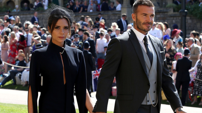 Victoria and David Beckham arrive hand-in-hand at a wedding