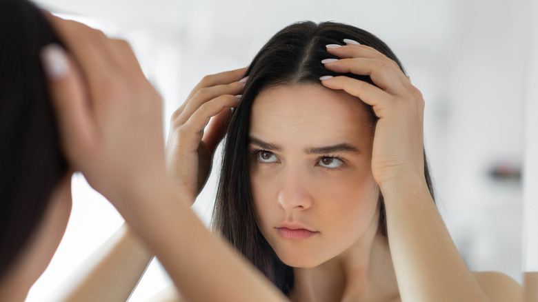 woman looking at hair loss