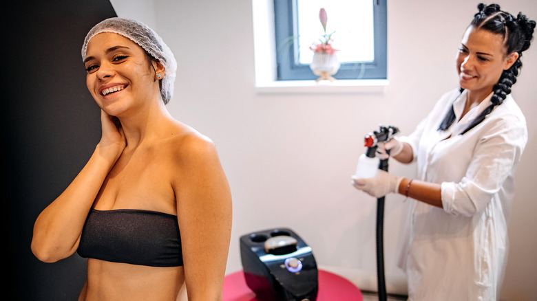 Woman receiving a spray tan