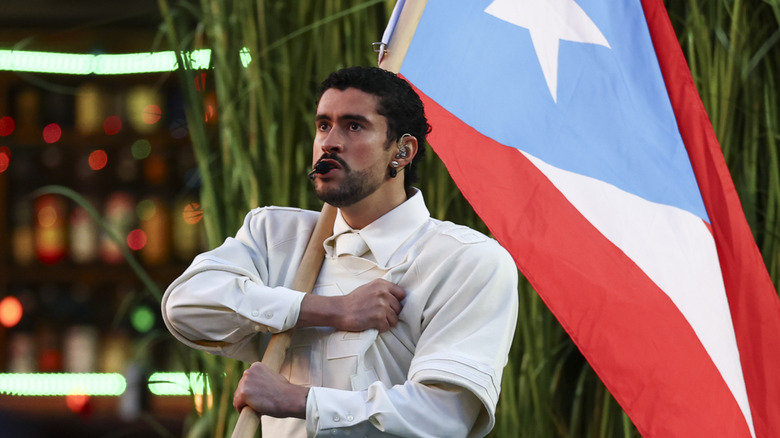 Bad Bunny performing at the Super Bowl while holding the Puerto Rican flag