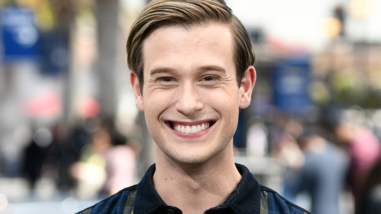 "Hollywood Medium's" Tyler Henry smiles in plaid